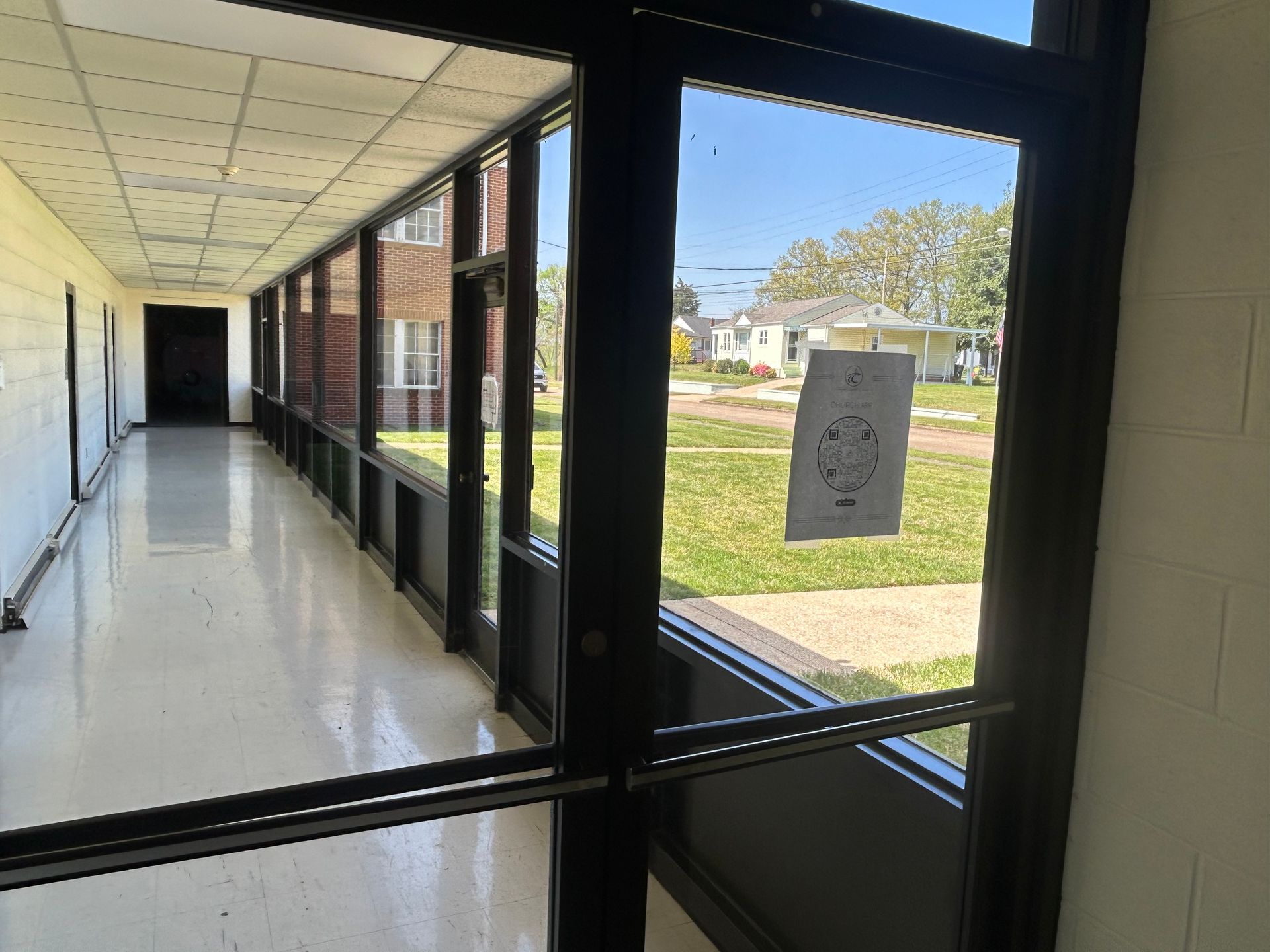 A long hallway with a lot of cleaned windows 