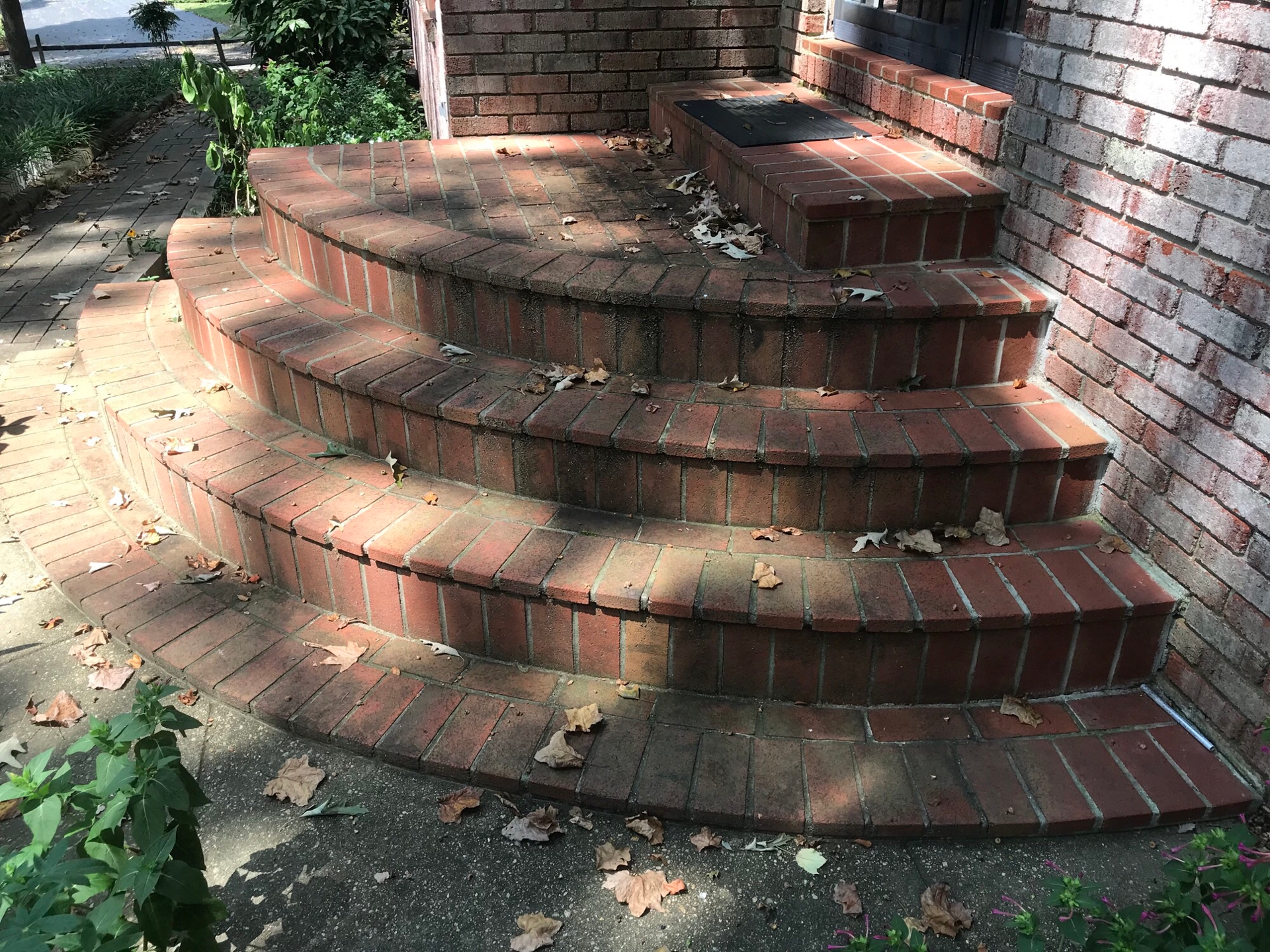 A set of brick stairs leading up to a brick building.