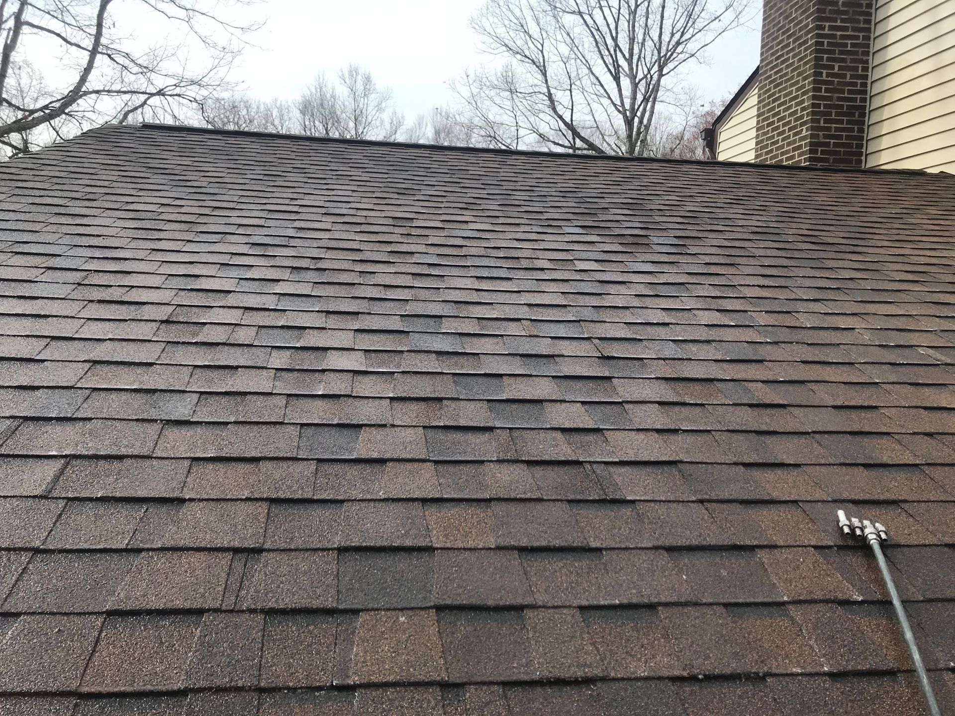 A close up of a roof with a hose attached to it.