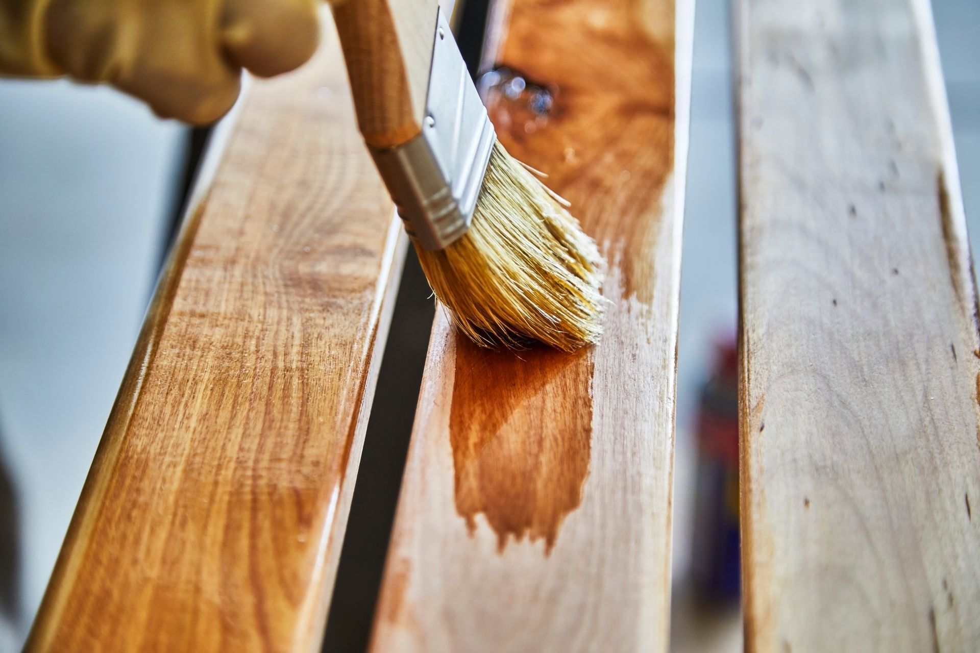 A Person Is Painting A Piece Of Wood With A Brush