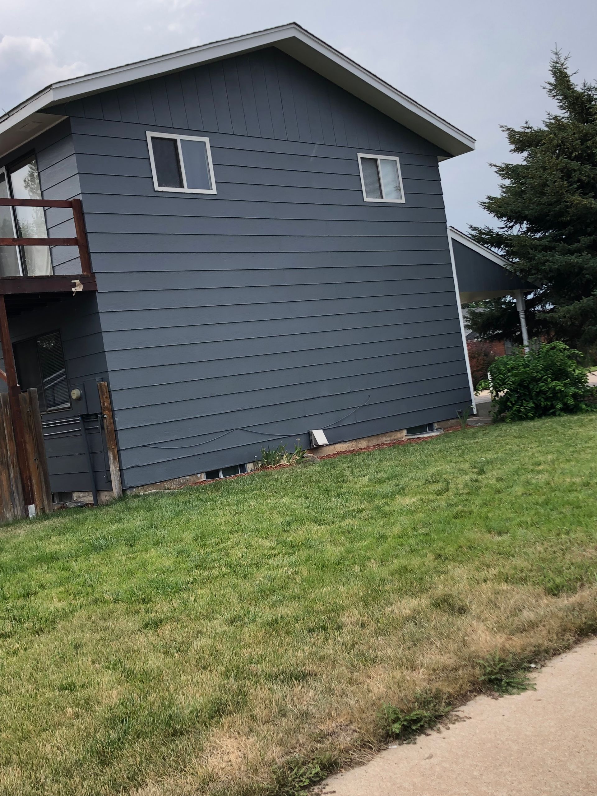 A Blue House With A Balcony On The Side Of It