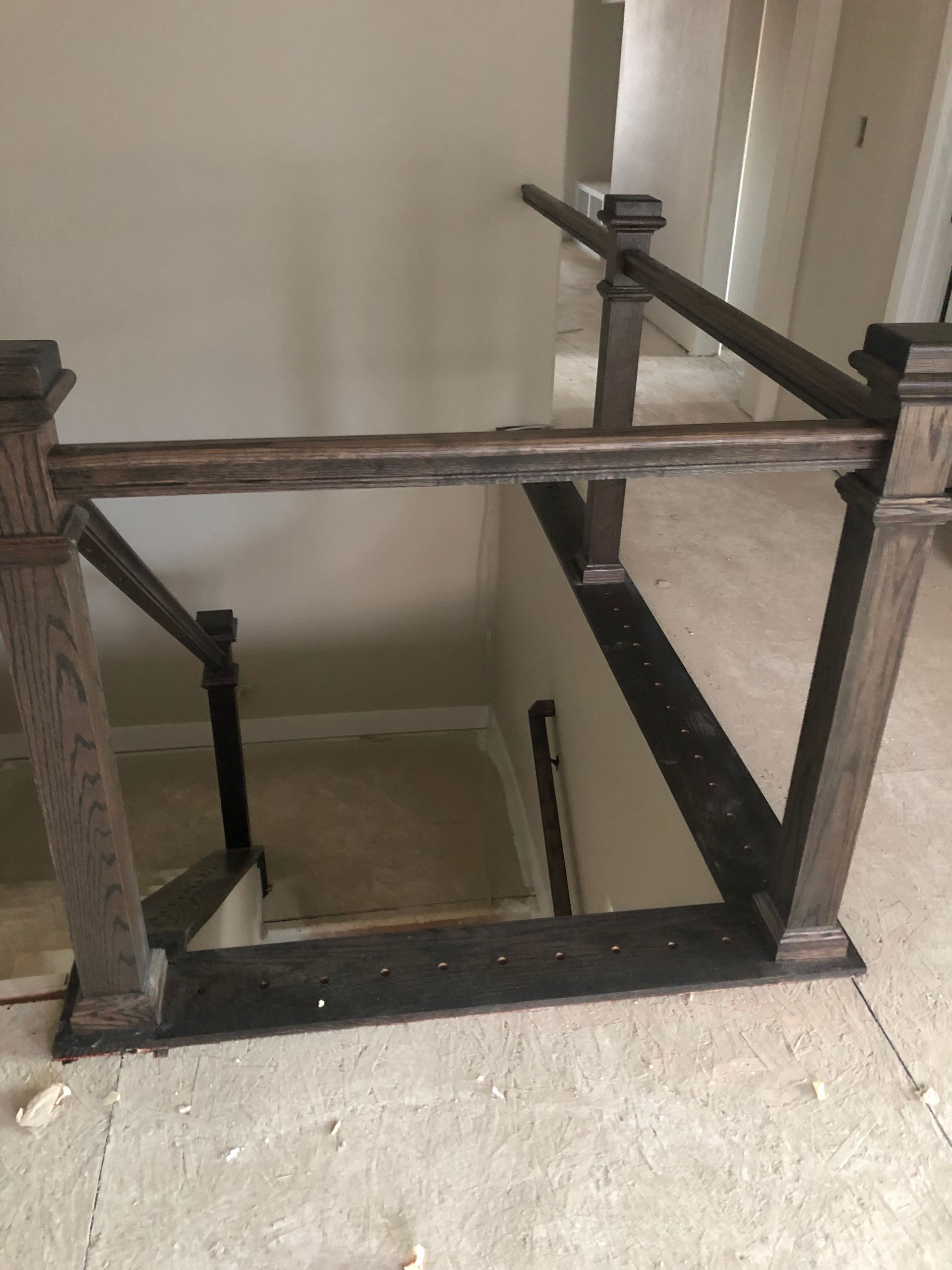 A Wooden Staircase With A Glass Railing In A House