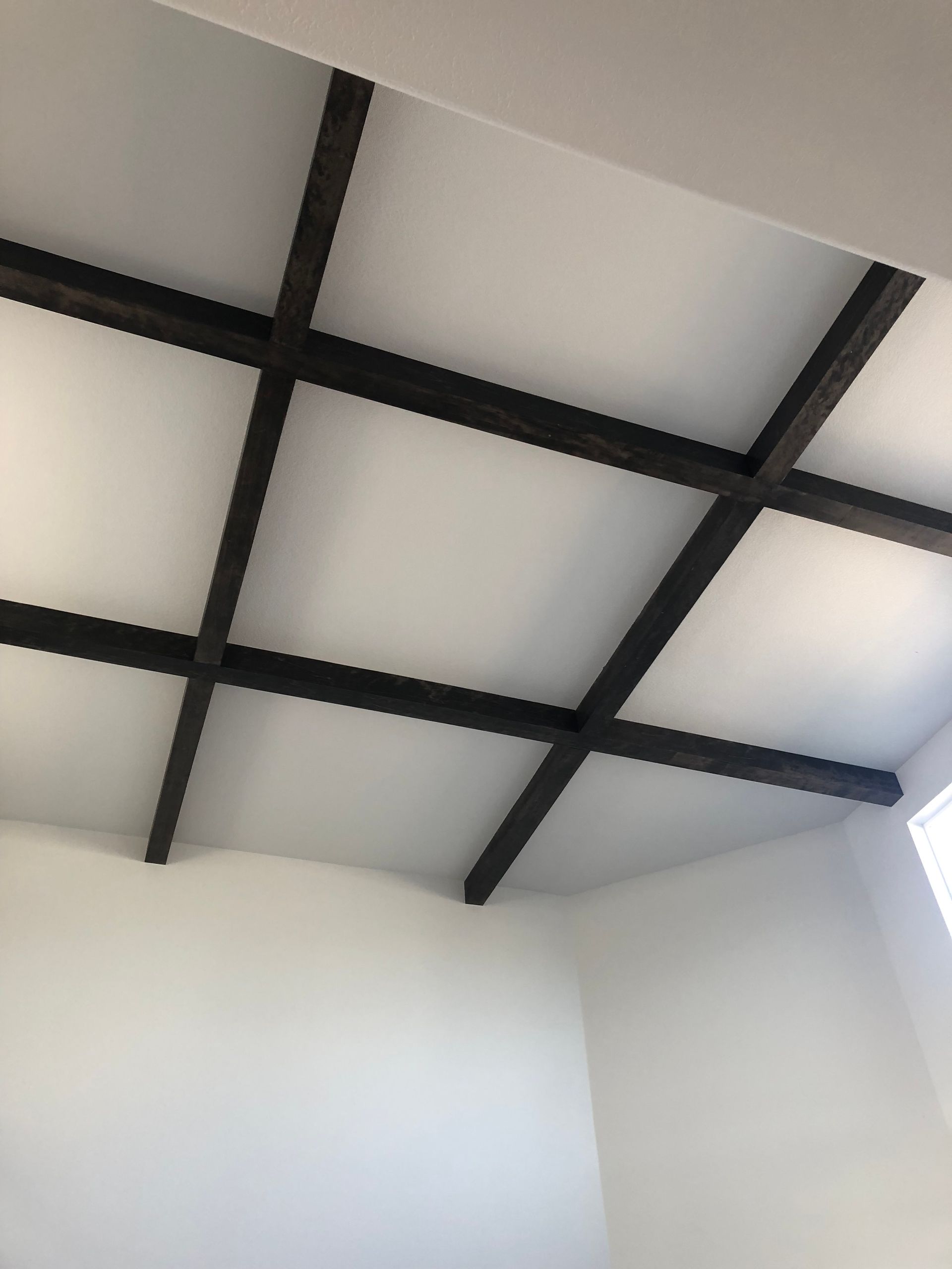 A Kitchen With White Cabinets , A Black Stove Top Oven , And A Microwave