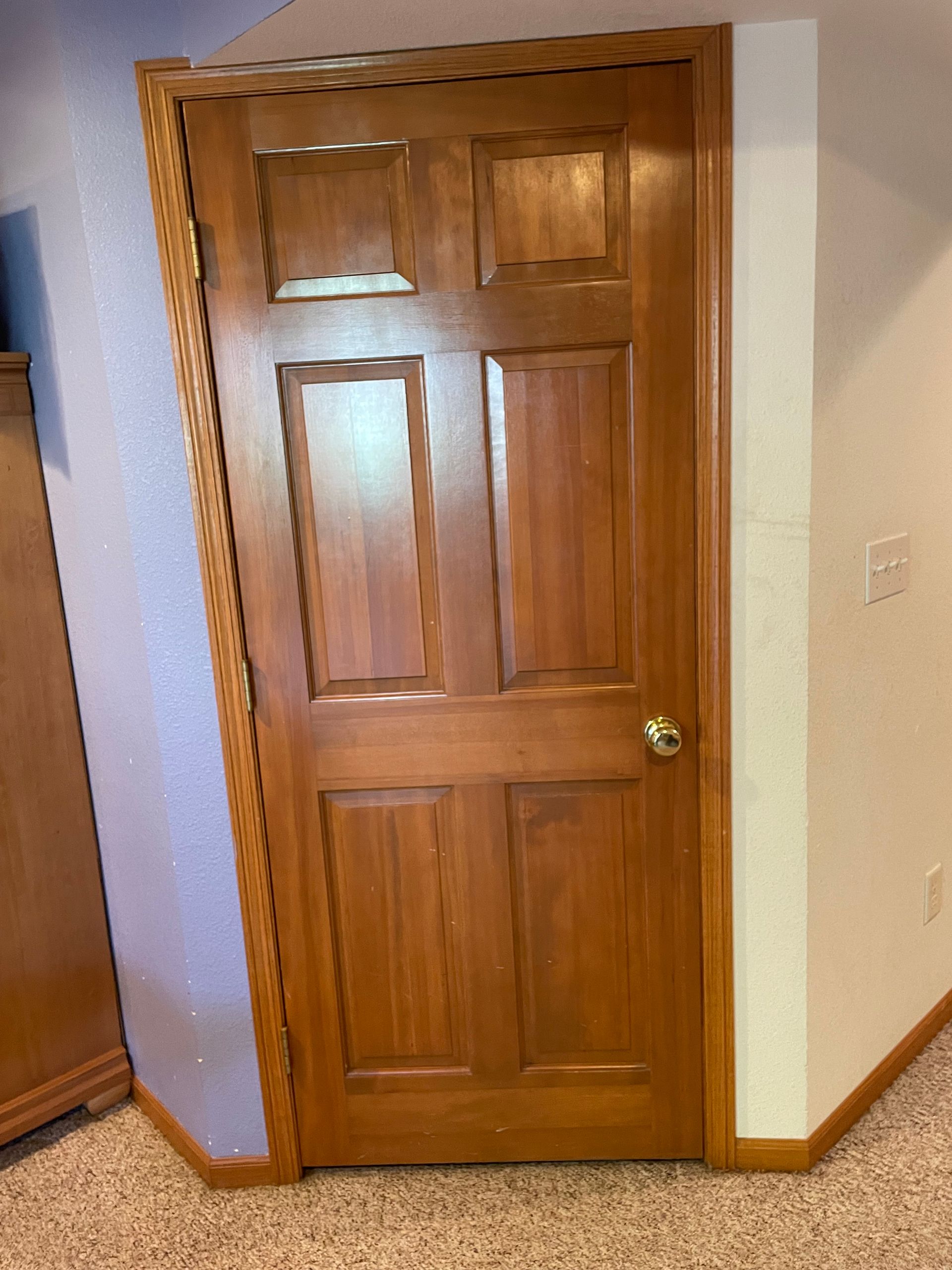 A Wooden Door Is Sitting In The Corner Of A Room