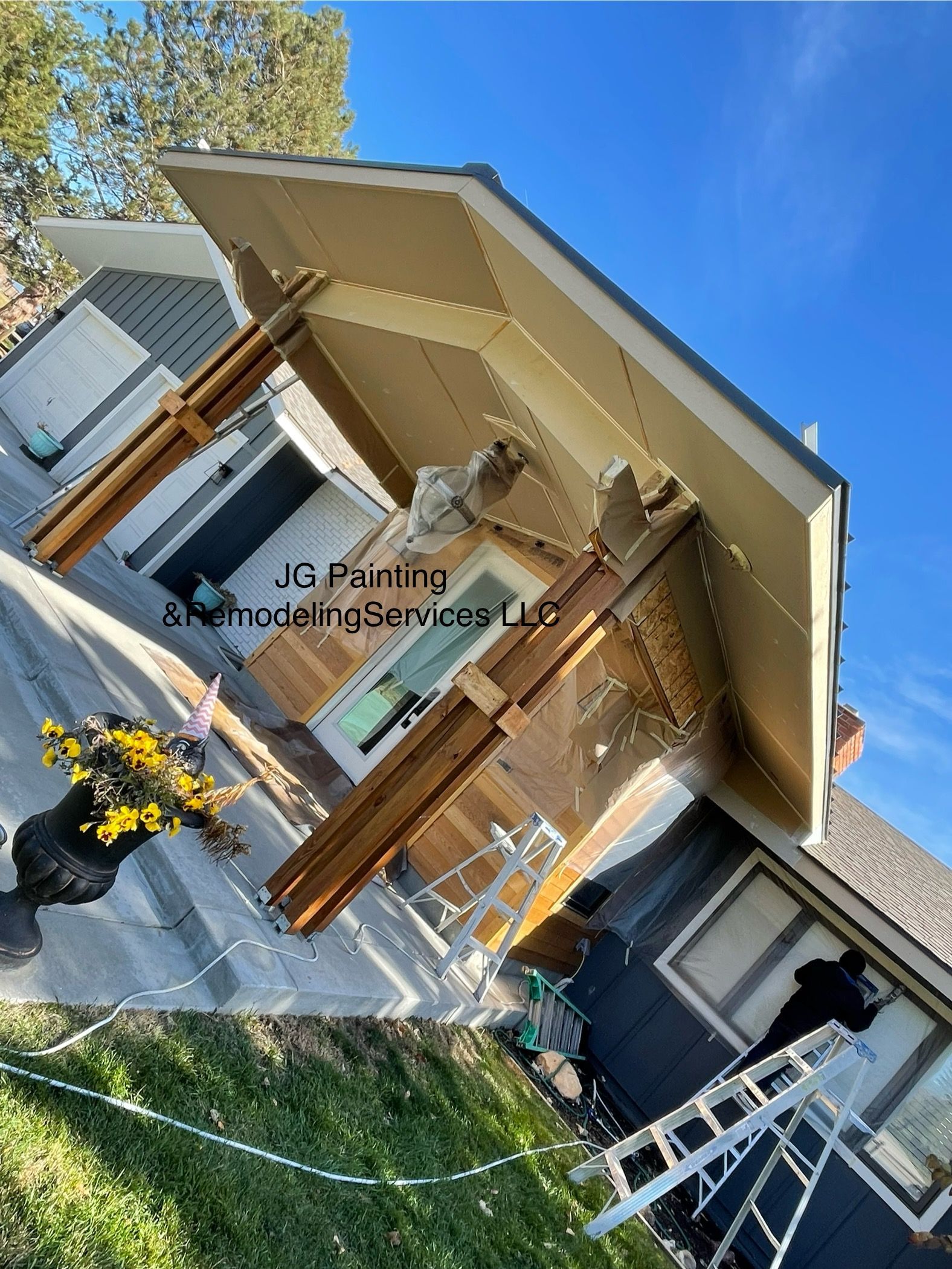 A House With A Roof That Is Being Painted