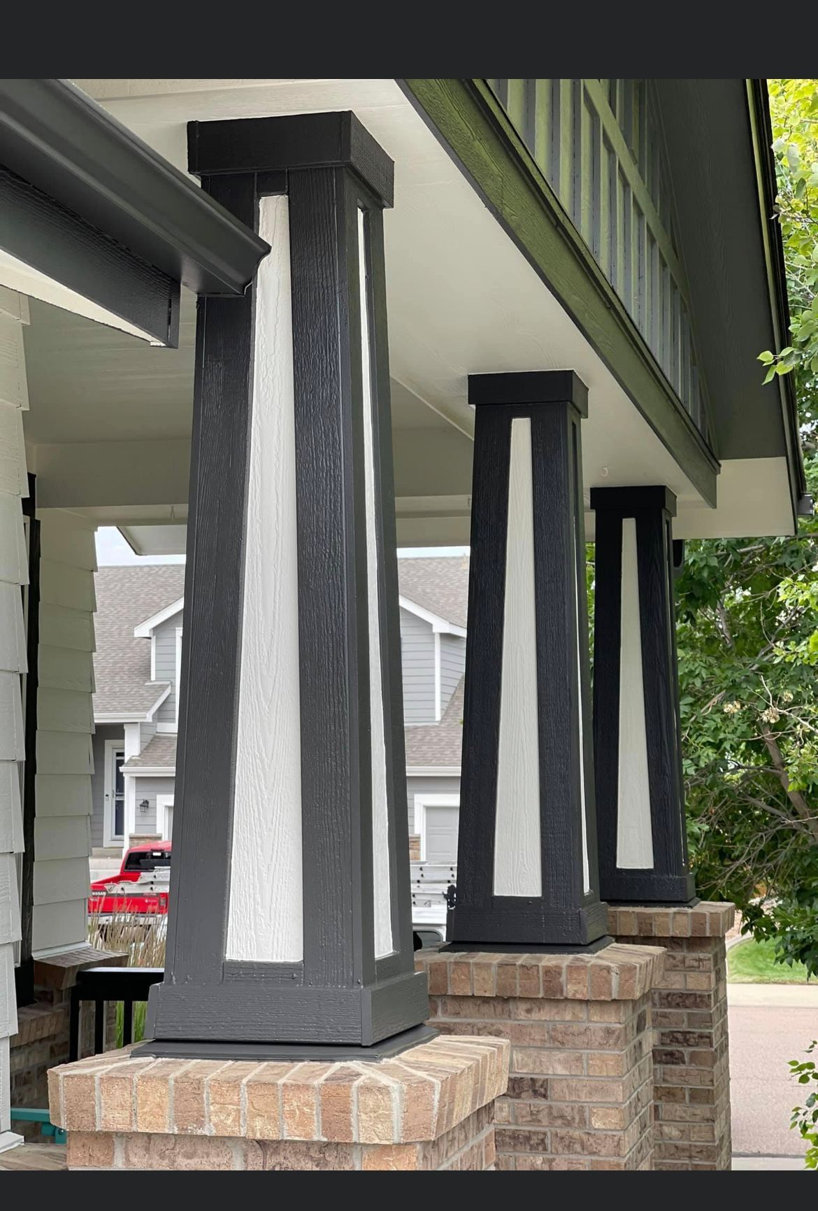 A Row Of Black And White Columns On A Porch Of A House