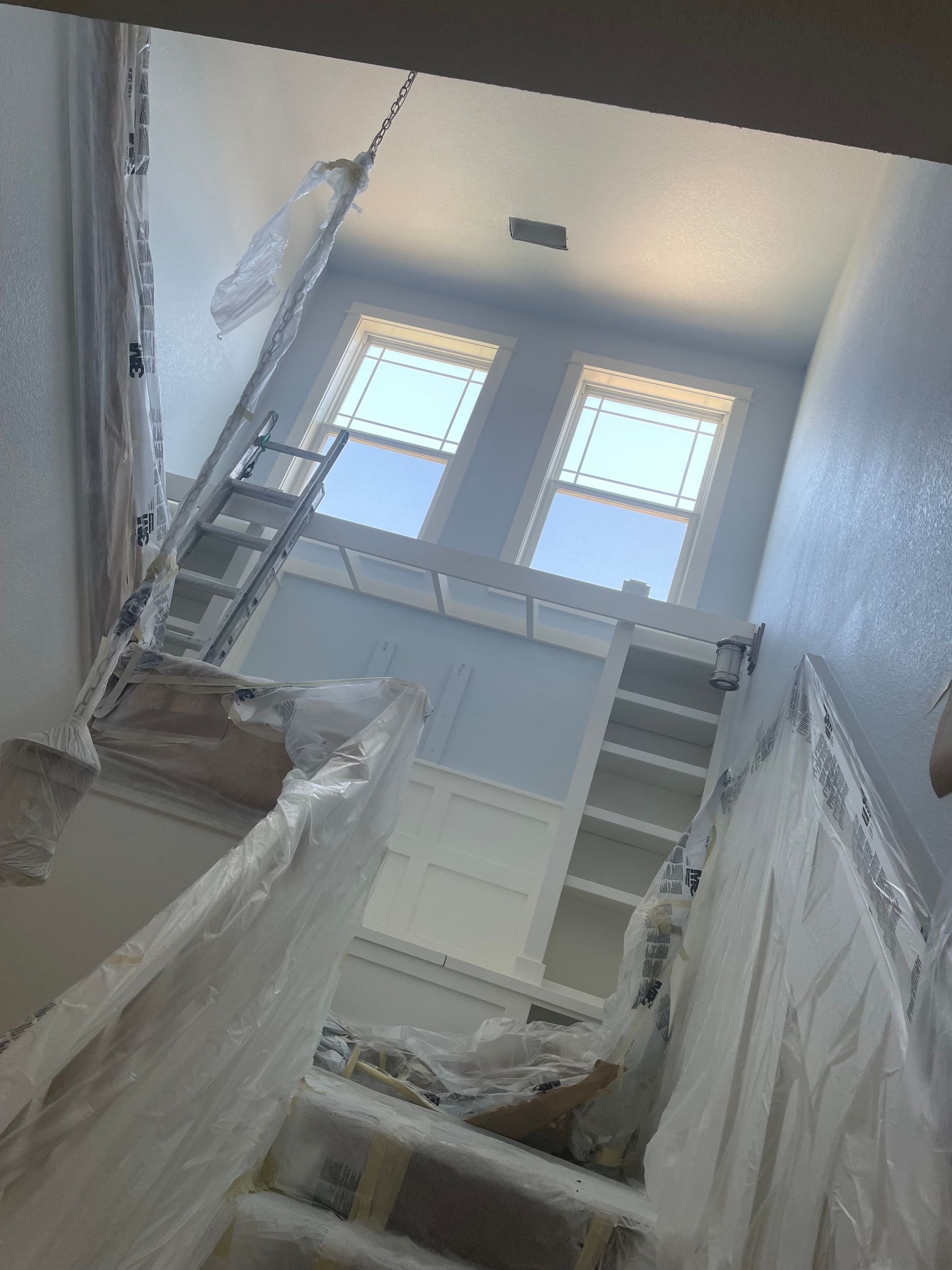 A Room Is Being Painted With A Ladder And Stairs