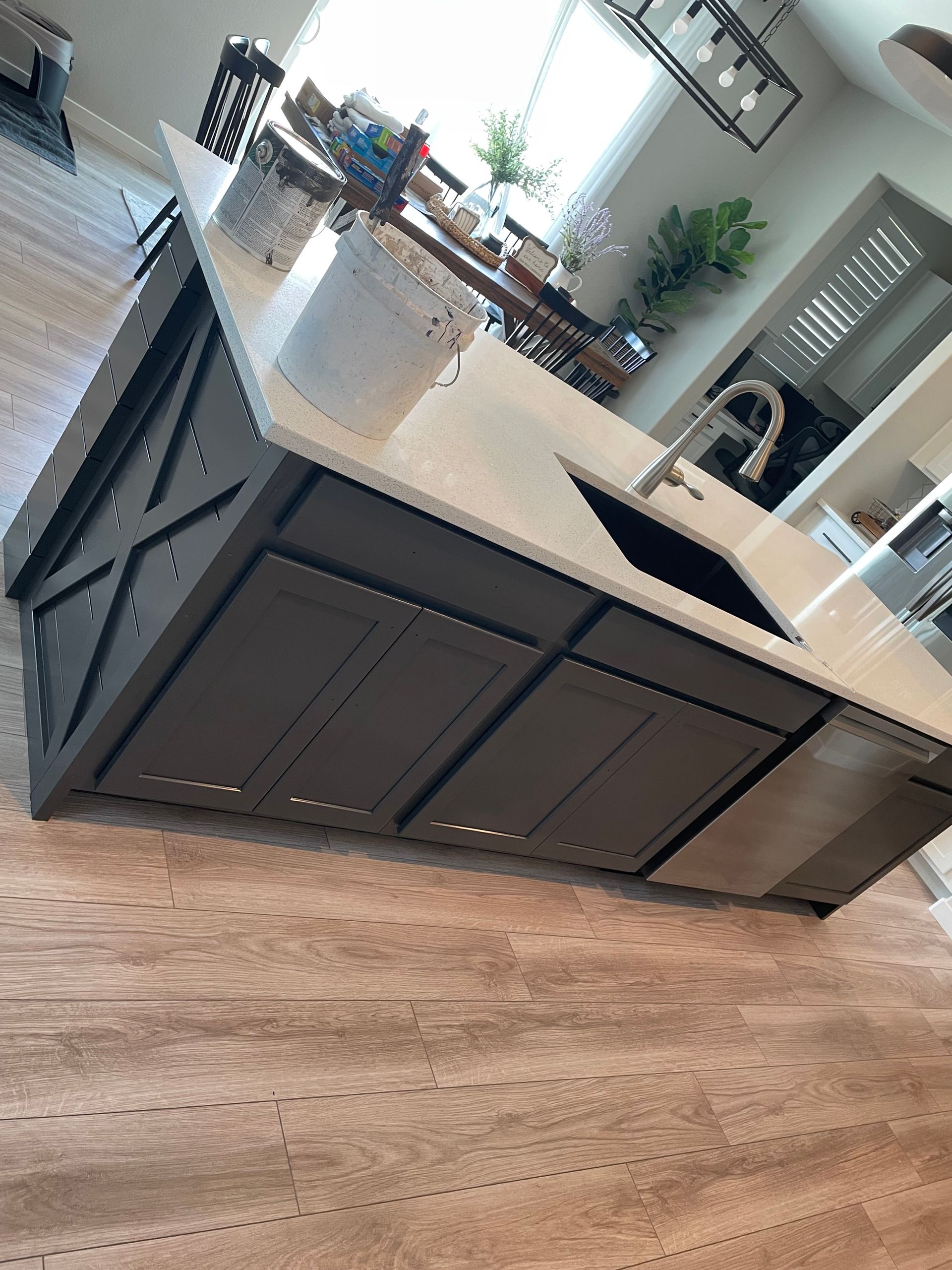 A Kitchen With White Cabinets , A Black Stove Top Oven , And A Microwave