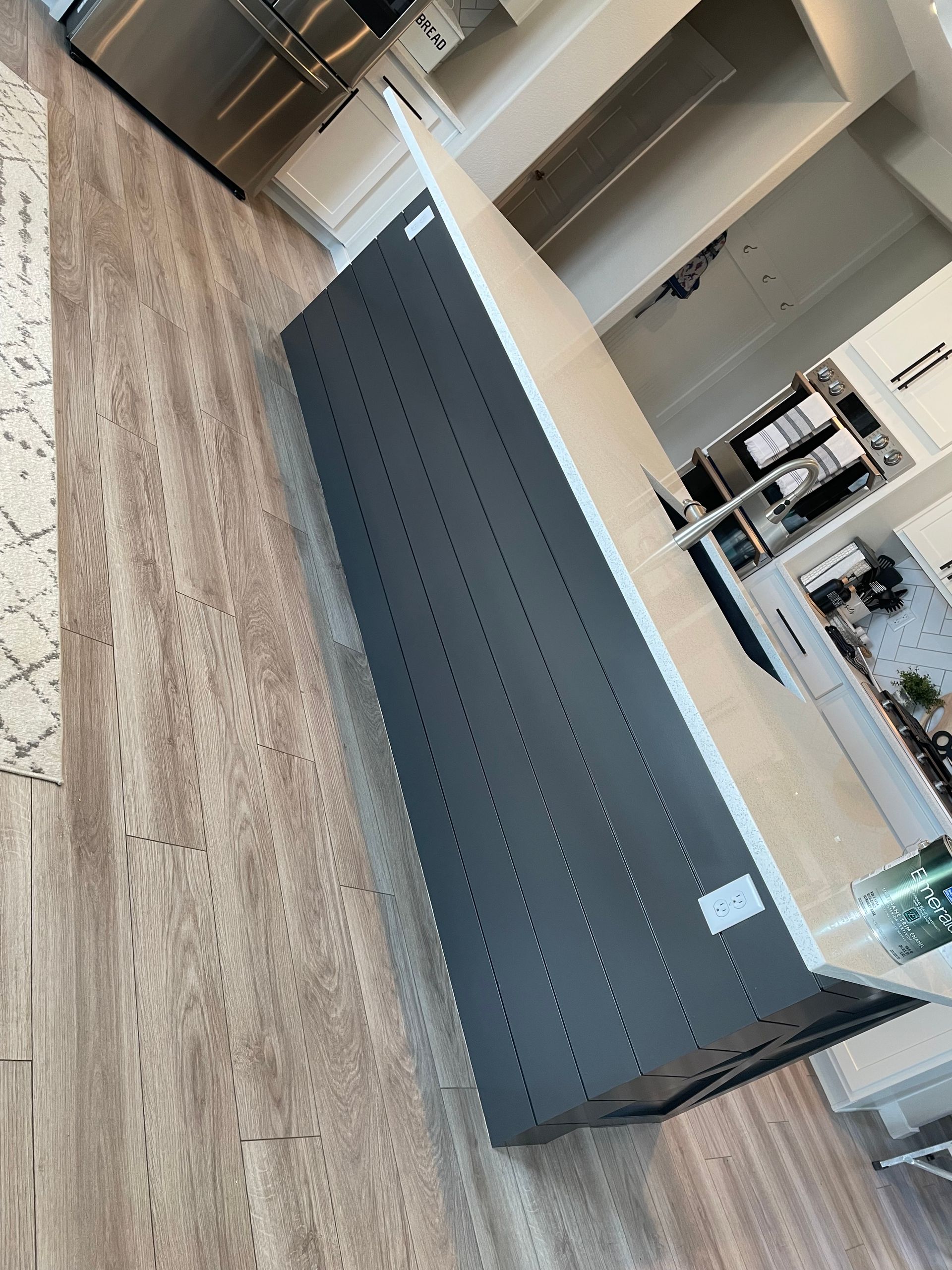 A Kitchen With A Large Island And Stainless Steel Appliances