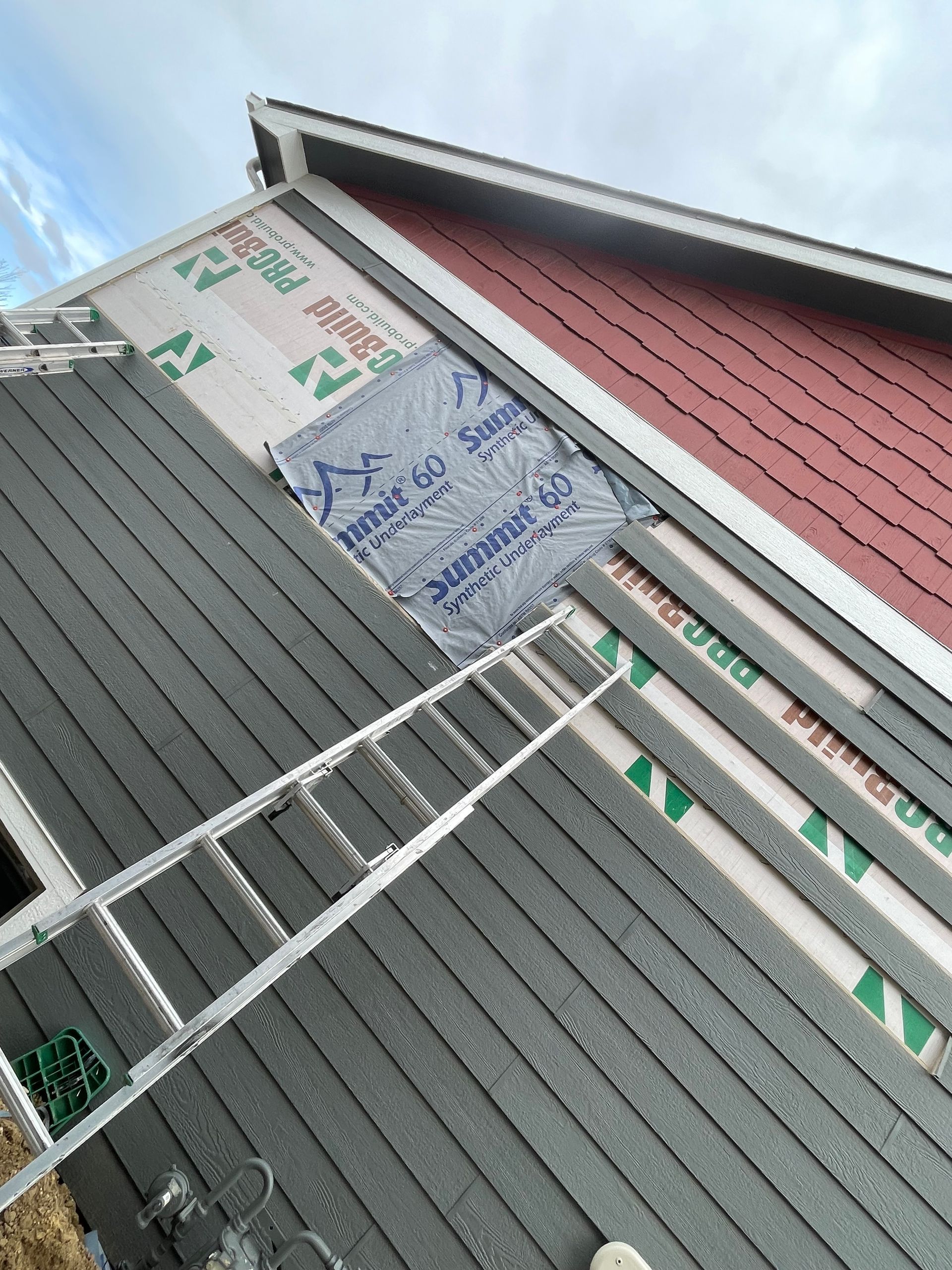 A Ladder Is Hanging From The Side Of A House