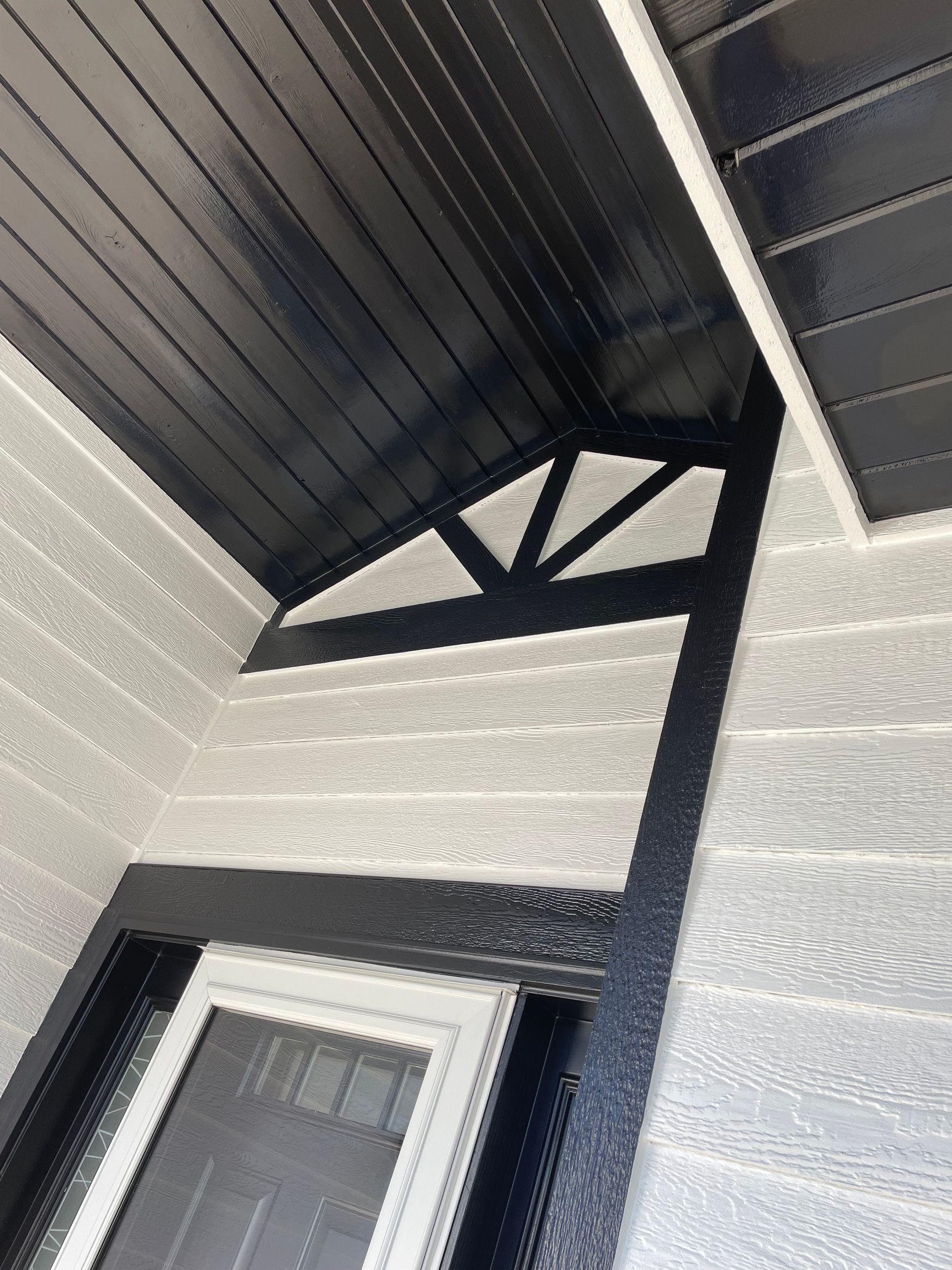 A Black And White House With A Window And A Black Ceiling