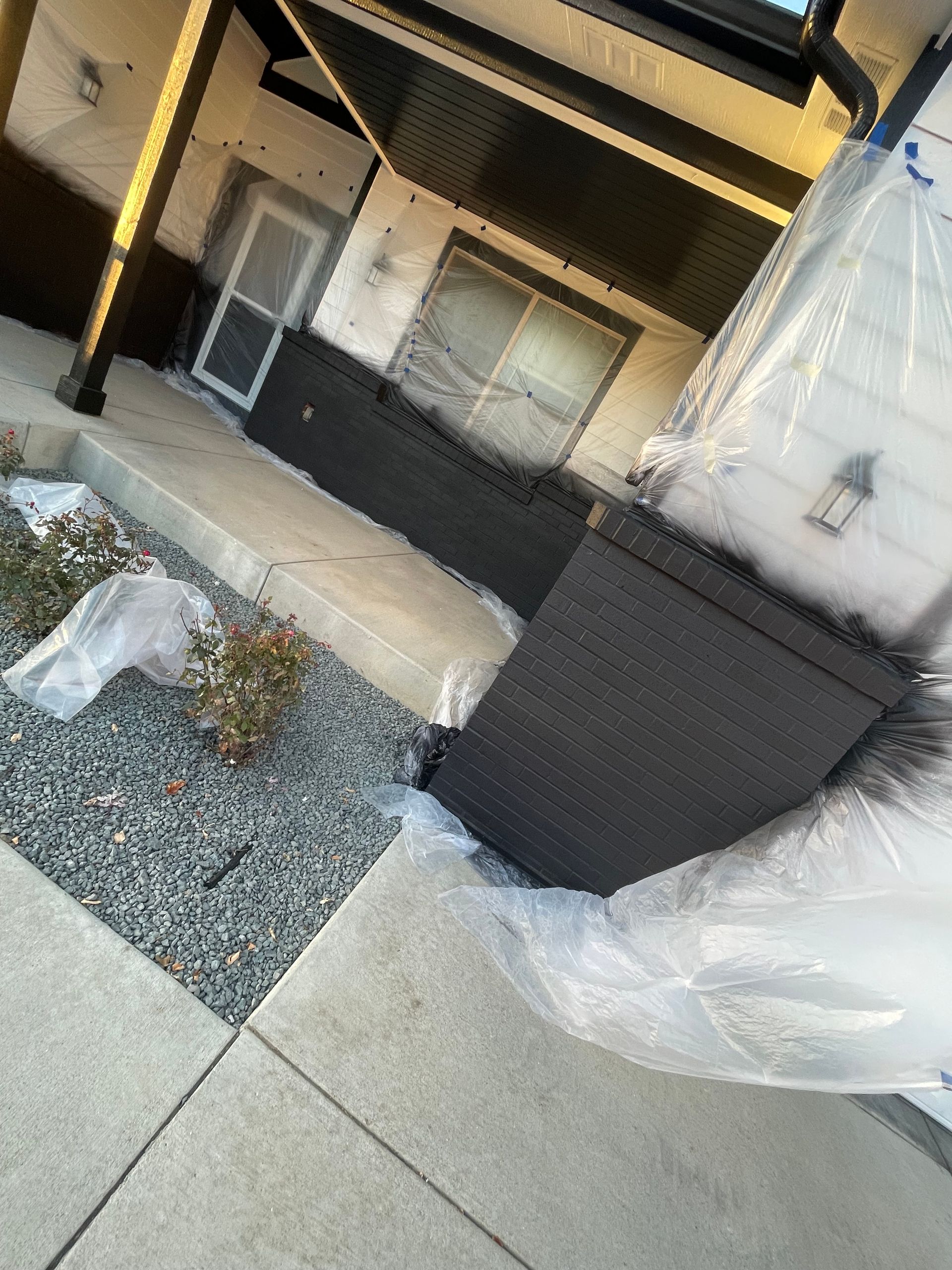 A Mattress Is Wrapped In Plastic Outside Of A House