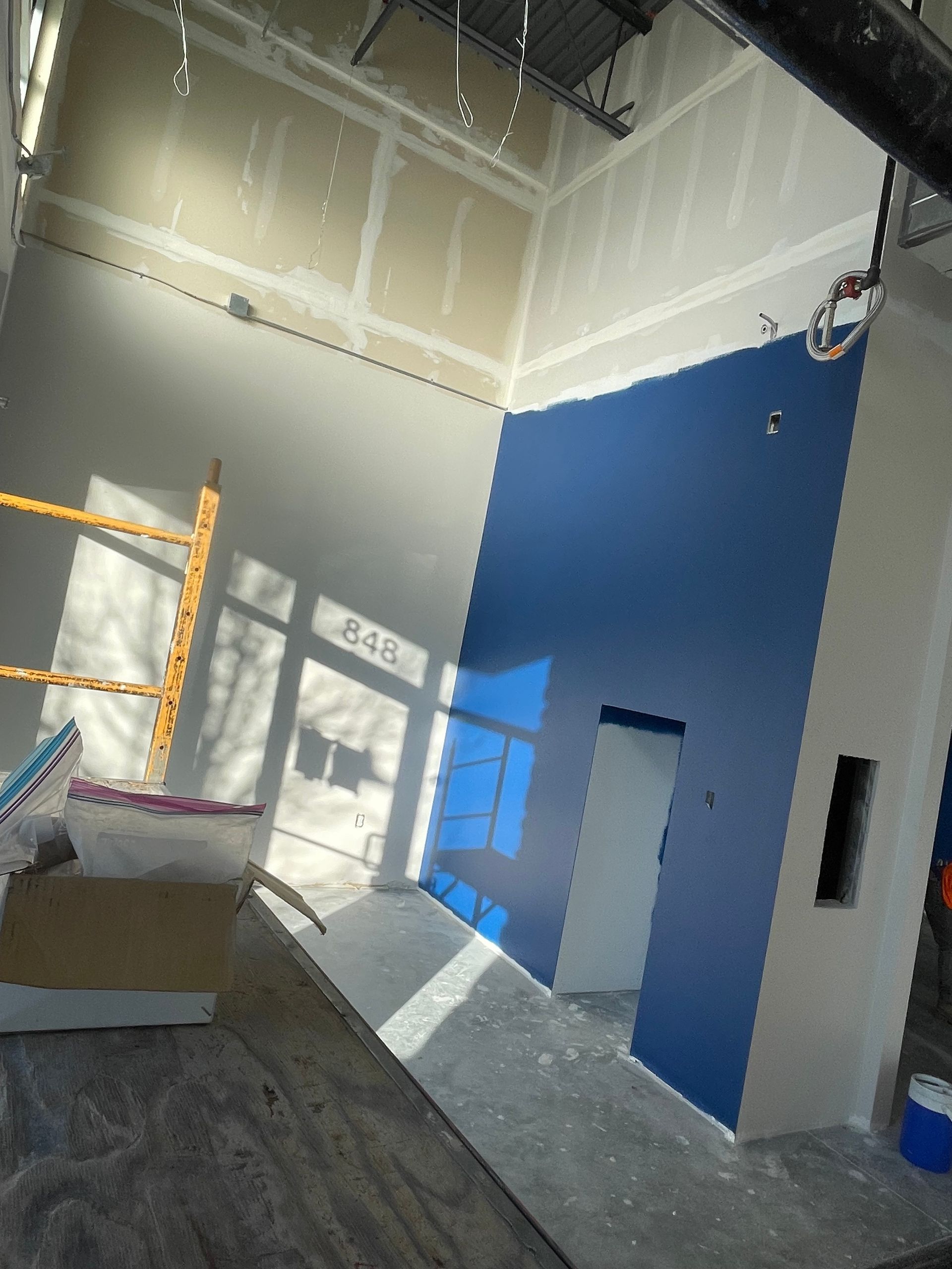 A Room With A Blue Wall And A Sign That Says Mail