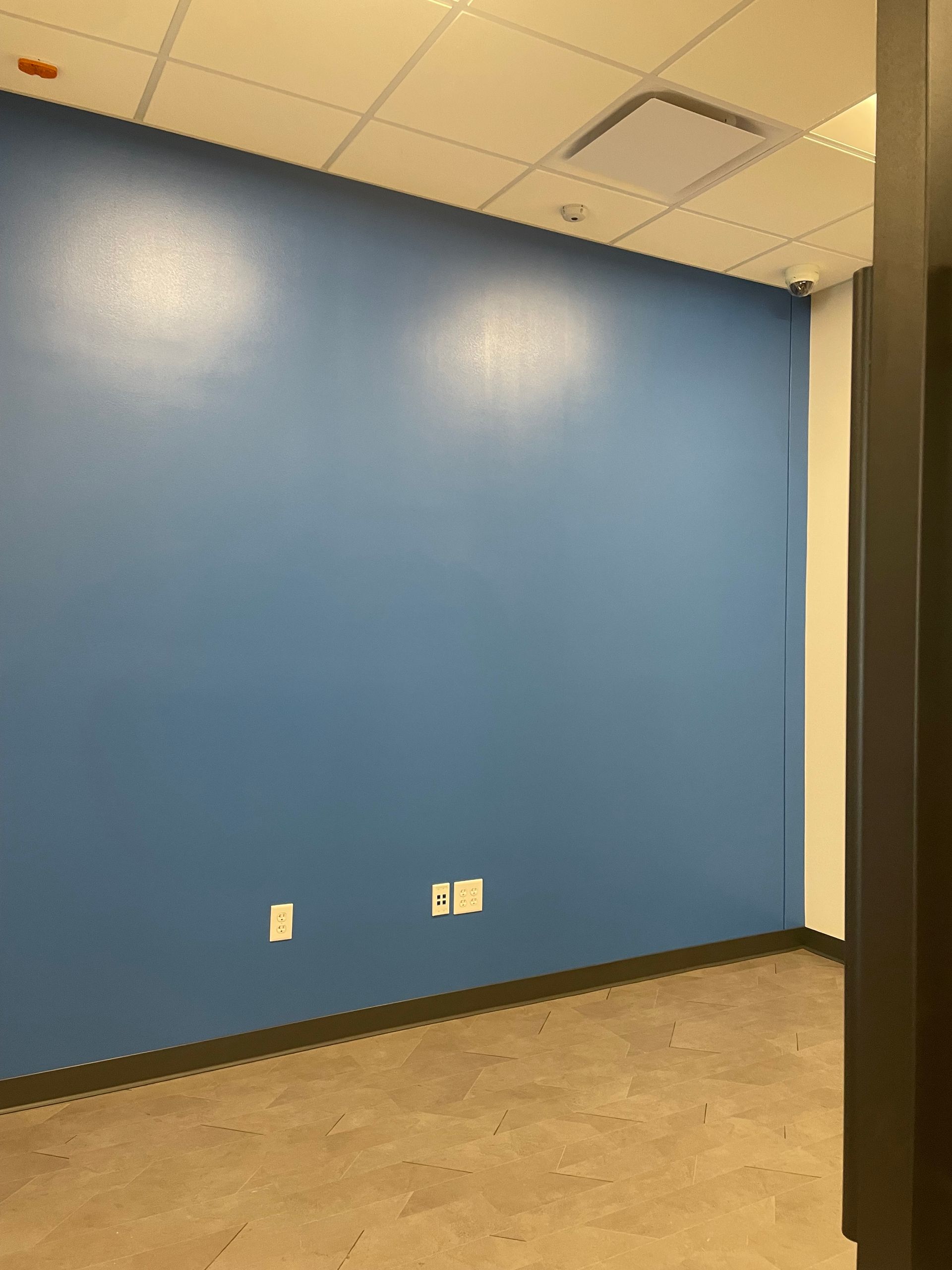 A Room With A Blue Wall And A Gray Floor