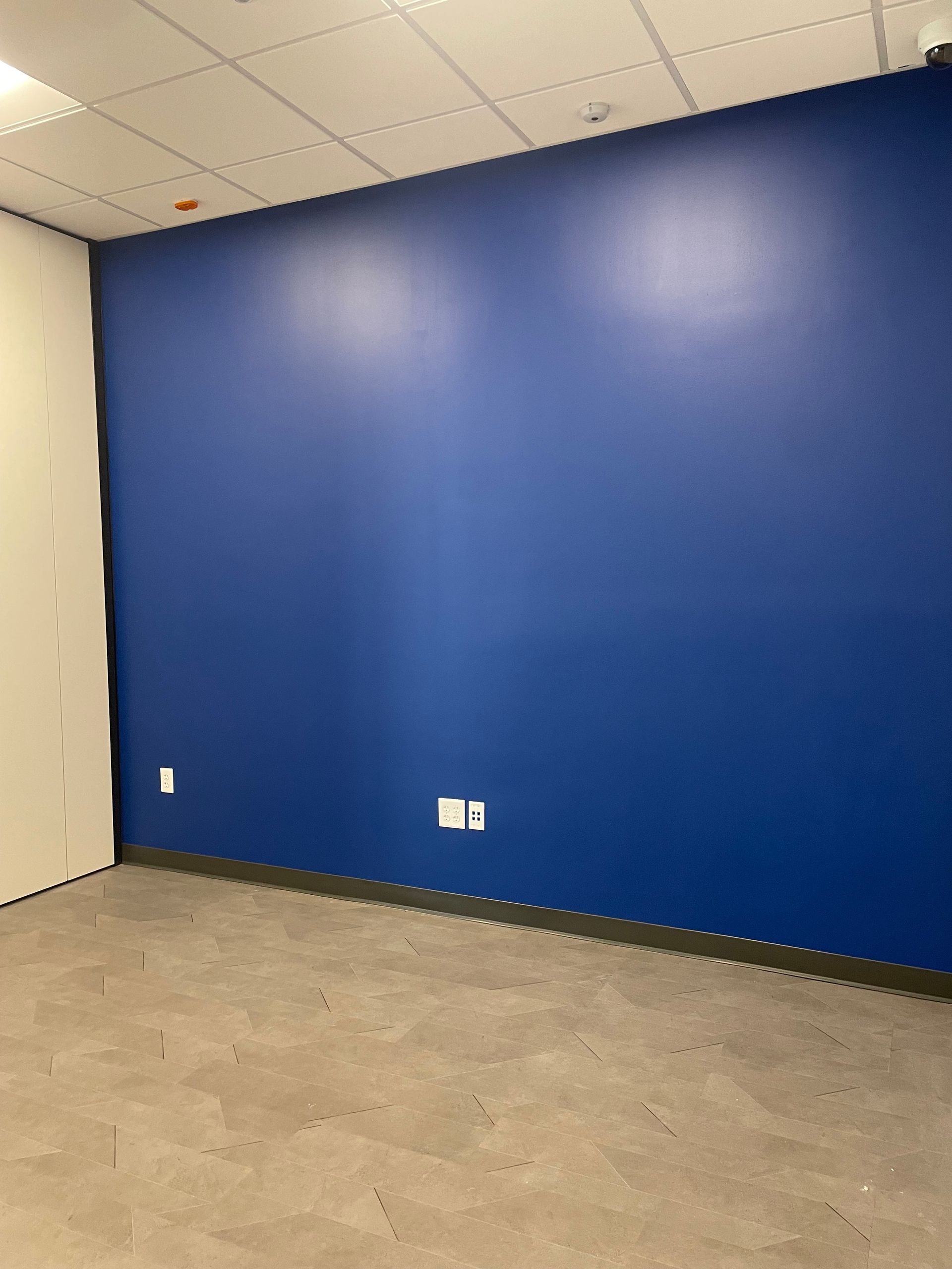 A Room With A Blue Wall And A Gray Floor