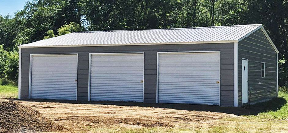 an aerial view of a red metal building with a white roof .