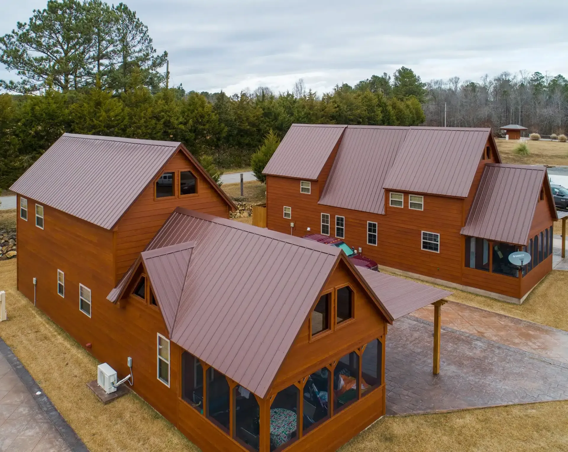 an aerial view of a group of log cabins with metal roofs