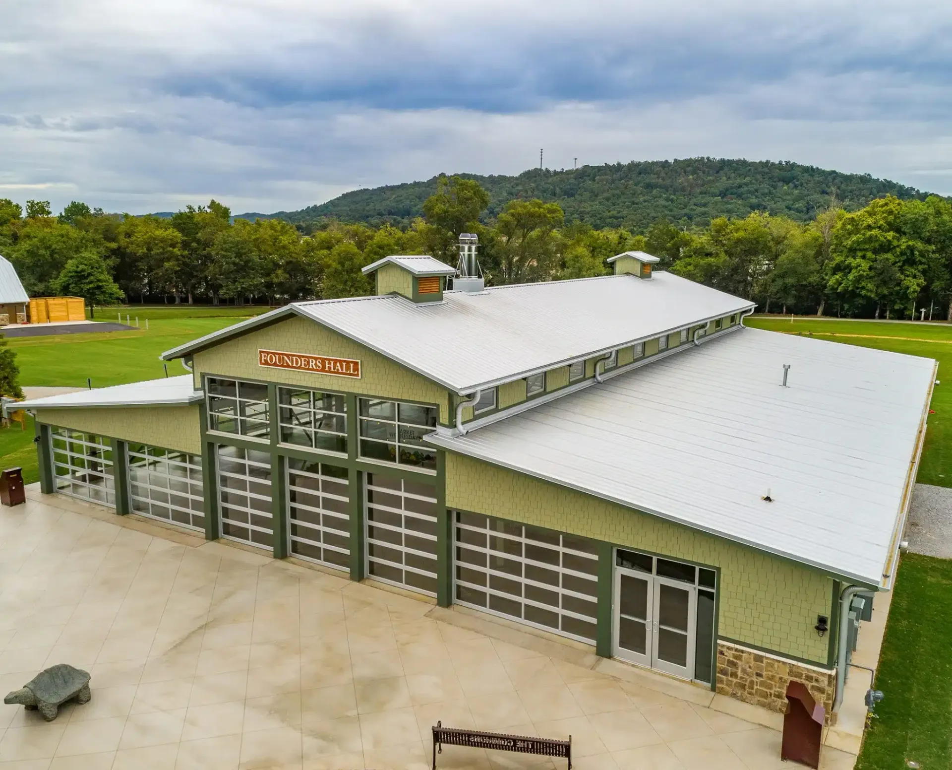 an aerial view of a large building with a white roof