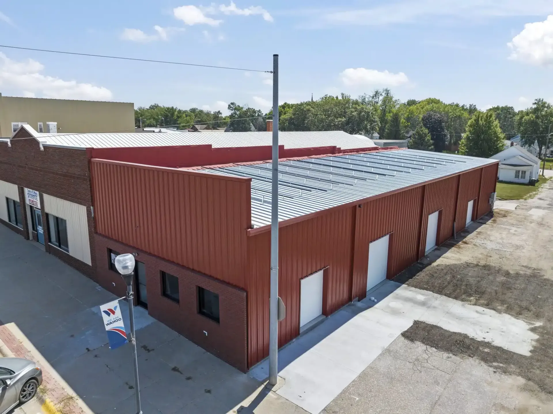 an aerial view of a large red building with a white roof .