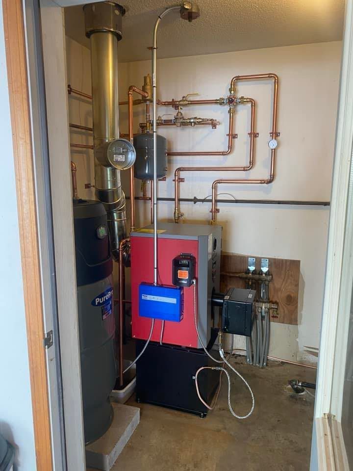 A room with a boiler and pipes in it