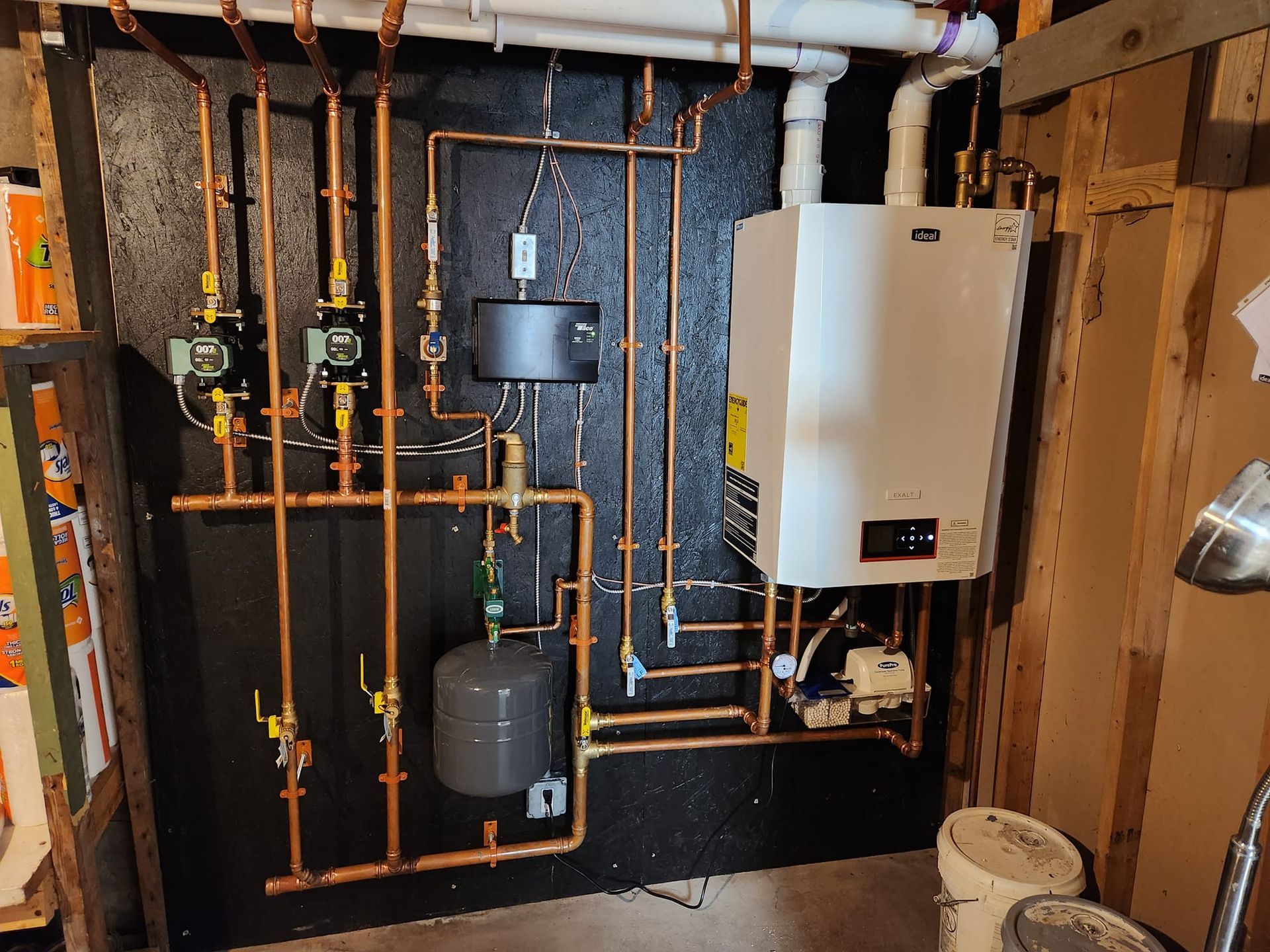 A woman with purple dreadlocks is standing next to a ladder and working on an air conditioner.