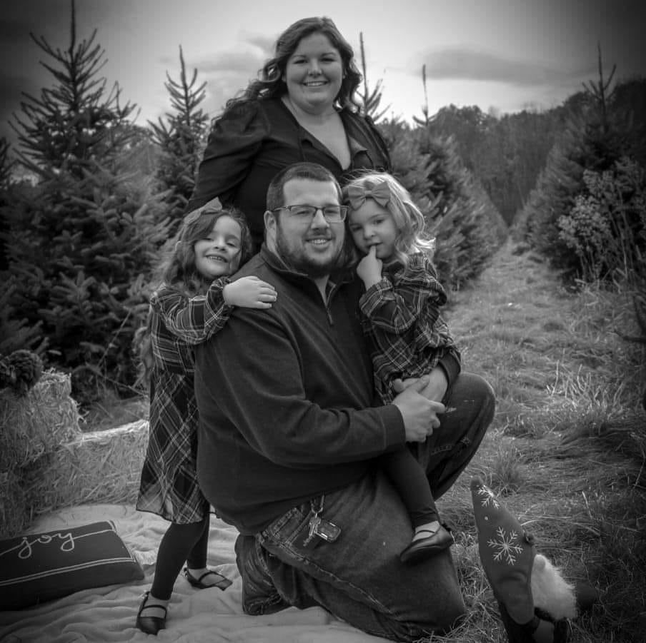 A mechanic is shaking hands with a customer in a garage.