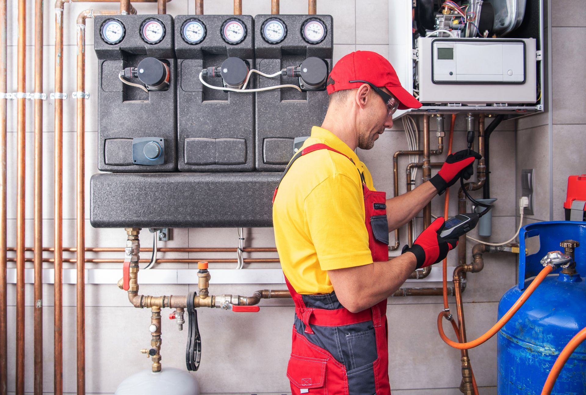 A man is working on a heating system in a room.