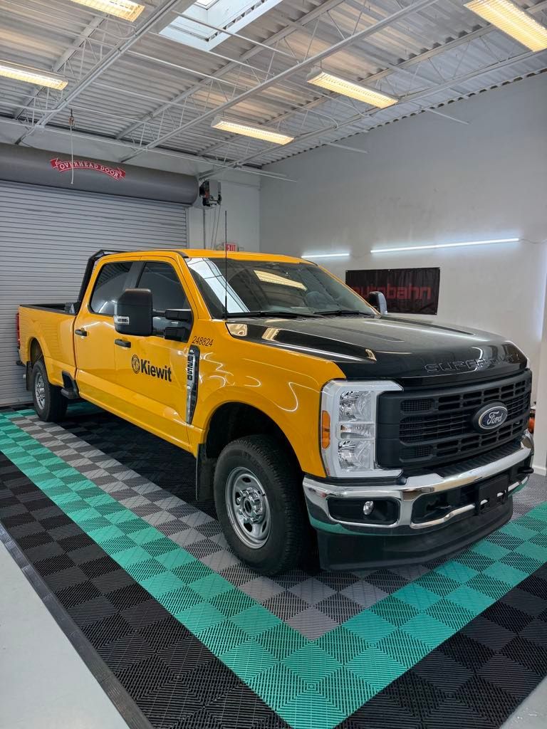 Ford Super Duty Kiewit truck with black ceramic tint, inside GT Tinting’s Hampton VA shop