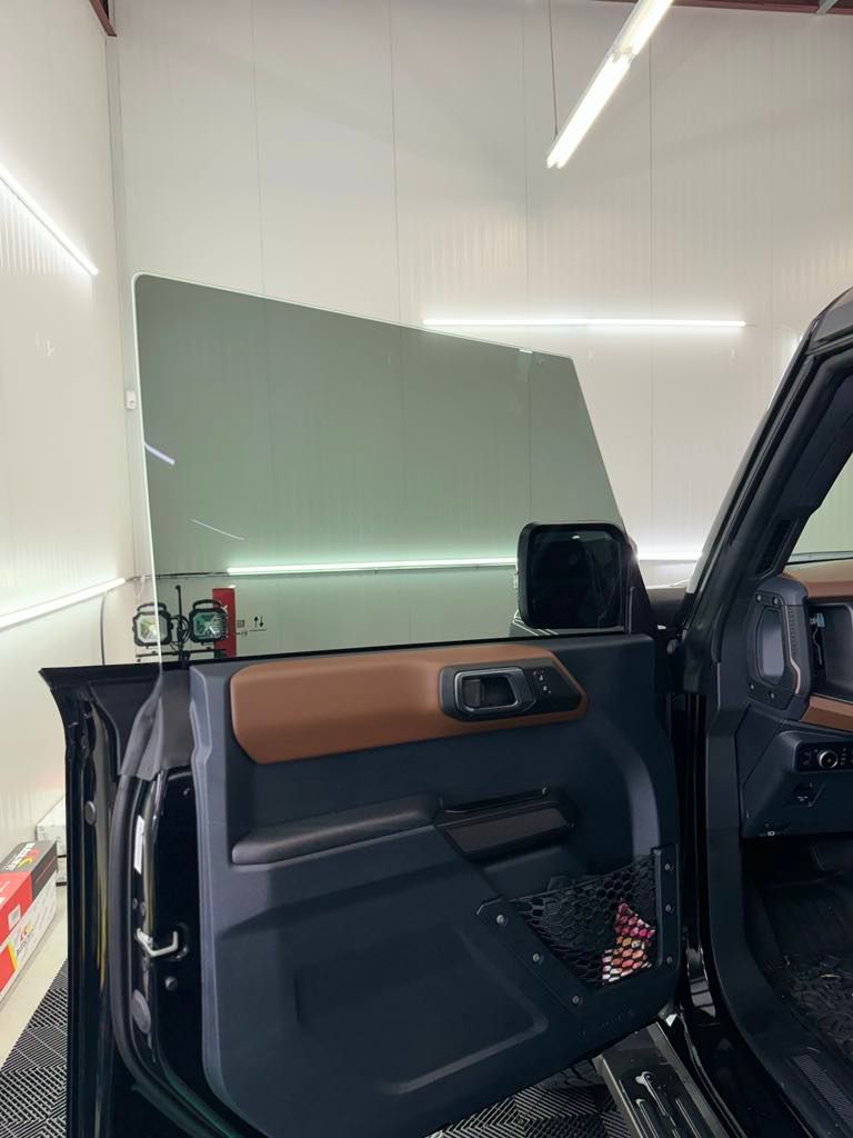 Interior view of a Ford Bronco with a window tinted using Autobahn Ceramic I3 film, showcasing a sleek and professional finish