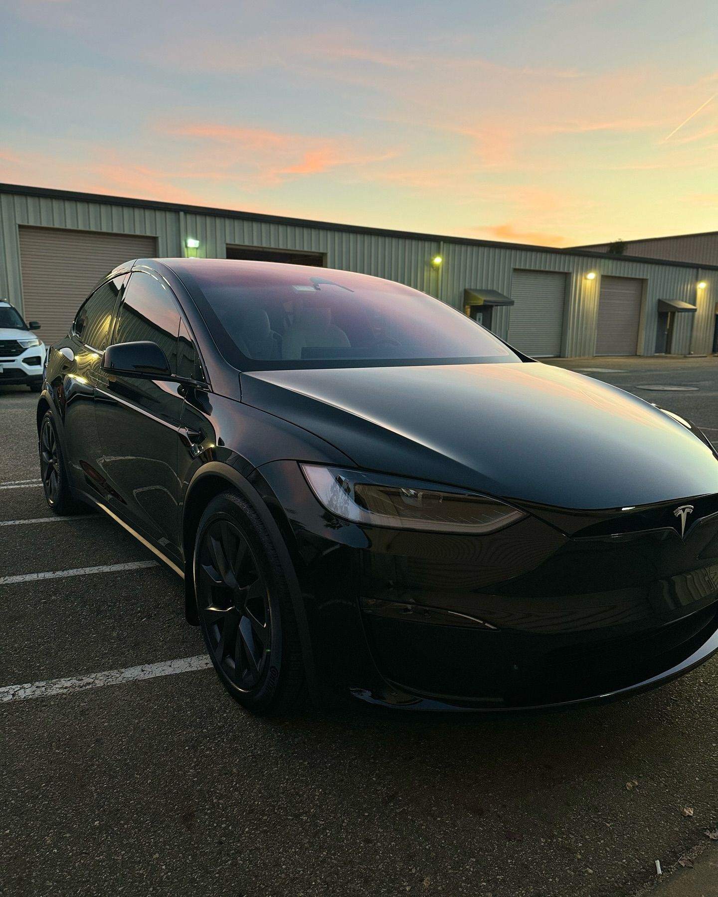 Tesla with a clean window tint installation in parking lot, showcasing expert tinting work by GT Tinting LLC in Hampton, VA