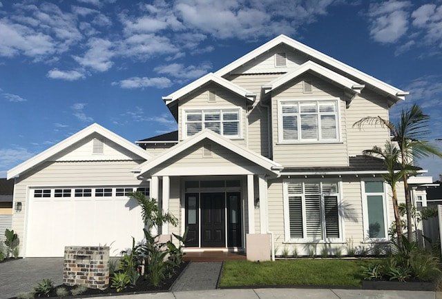 A large white house with a garage and a lot of windows