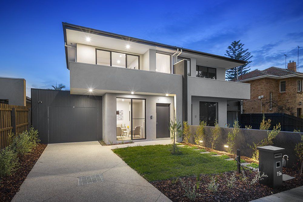 A modern house with a large lawn in front of it