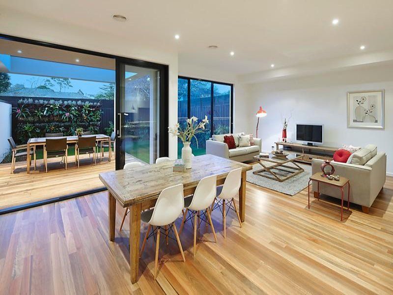 A living room with a dining table and chairs and a couch.
