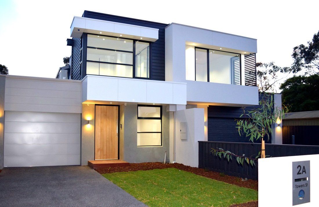 A modern house with a lawn in front of it