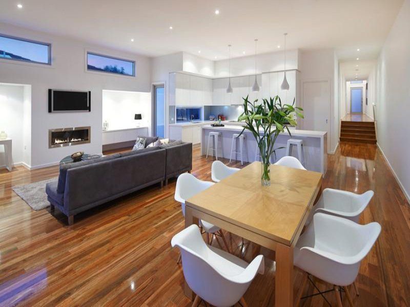 A living room with a dining table and chairs and a couch.