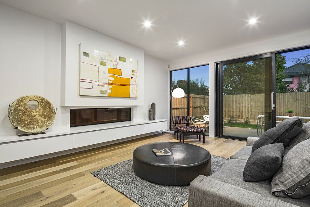 A living room with a couch , coffee table and fireplace.