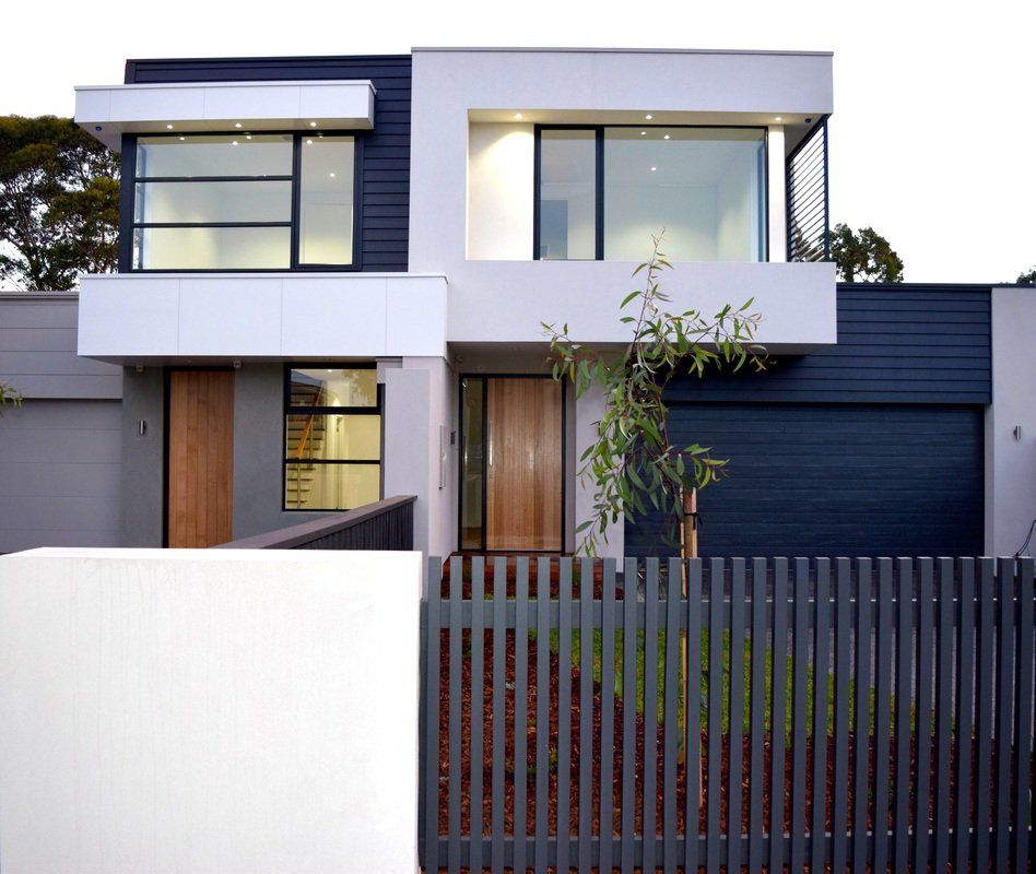 A modern house with a fence in front of it