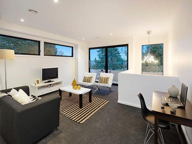 A living room with a couch a table and a television