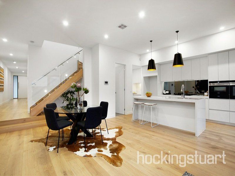 A kitchen with a cowhide rug on the floor