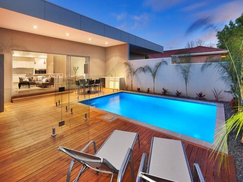 A house with a large swimming pool in the backyard