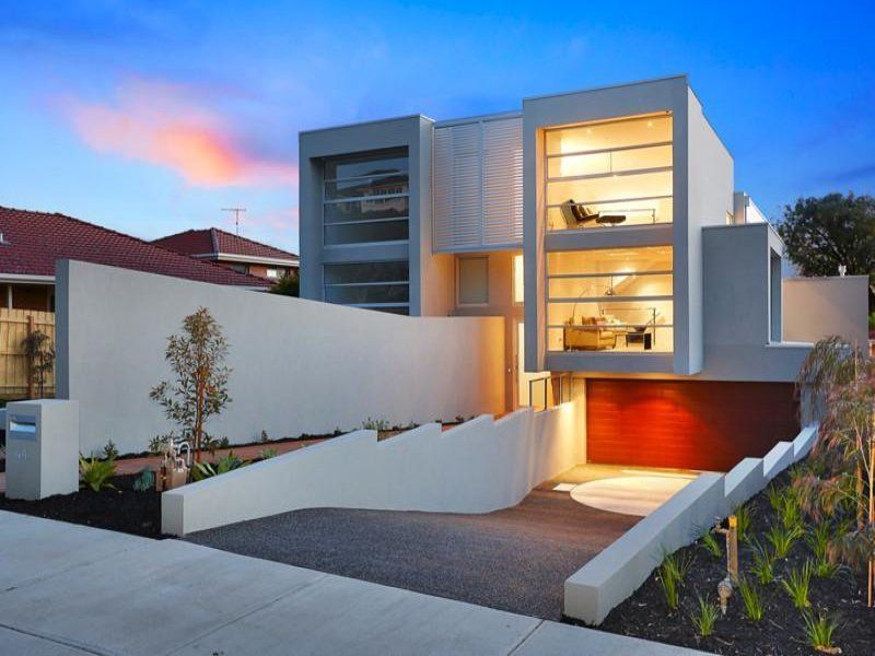 A large white house with a red garage door