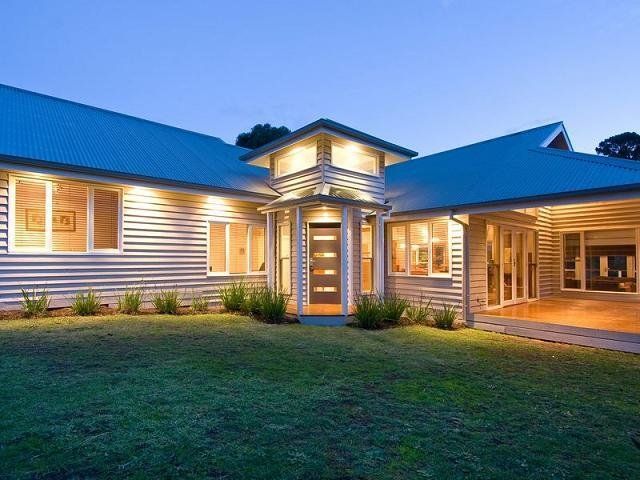 A large house with a blue roof and lots of windows