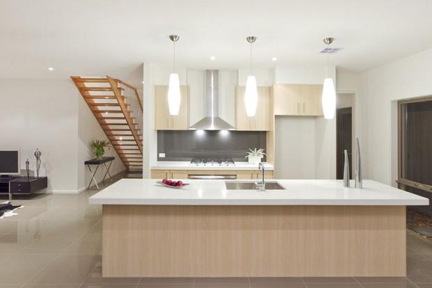 A kitchen with wooden cabinets and white counter tops