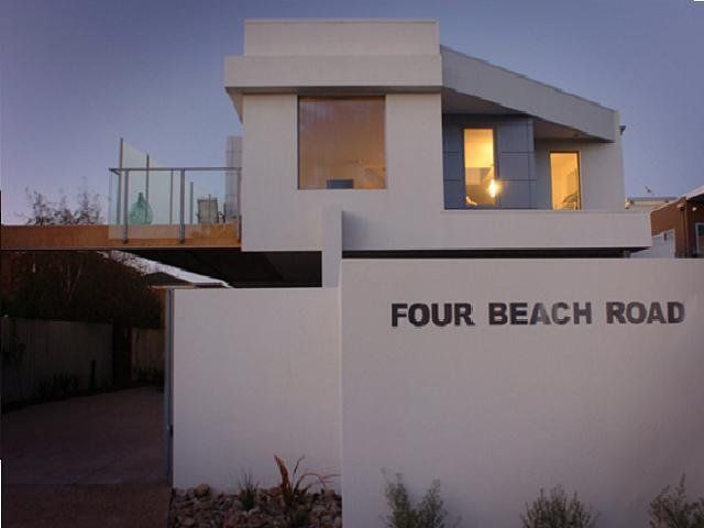 A white house with four beach road written on it