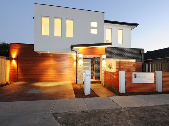 A large white house with a wooden garage door