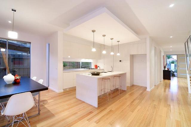 A kitchen with a large island and a dining table