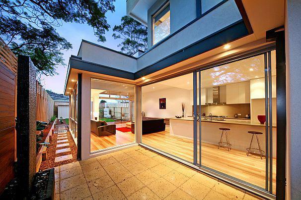 A modern house with a patio and sliding glass doors