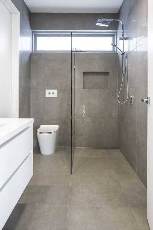A bathroom with a walk in shower and a toilet.
