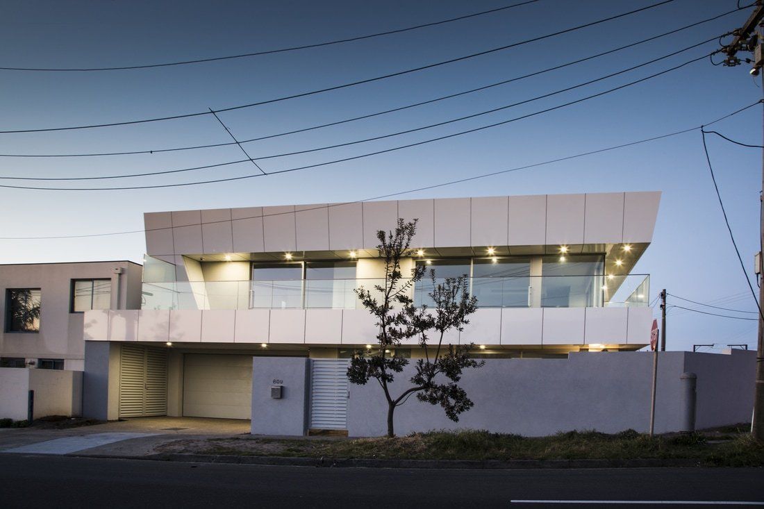 A large white building with a tree in front of it