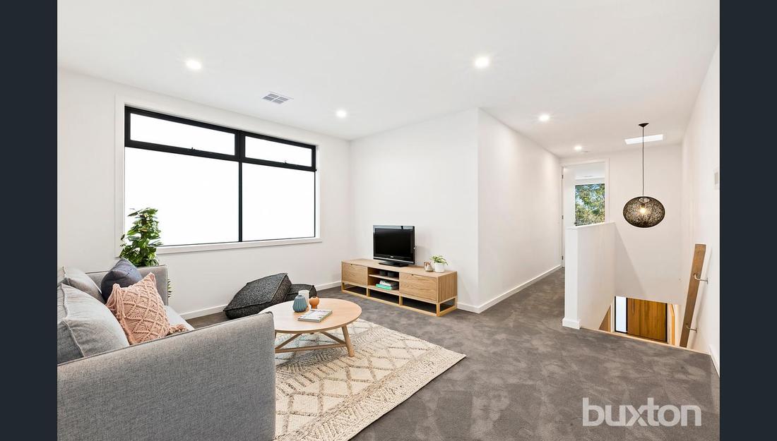 A living room with a couch , table , and television.